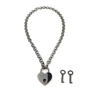 Detailed macro view of gunmetal Cuban chain with a heart-shaped padlock and two small keys