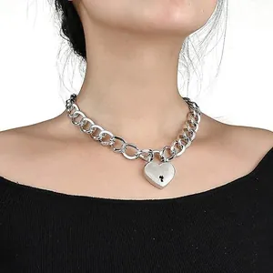 Silver chunky chain necklace with a heart padlock pendant shown on a model