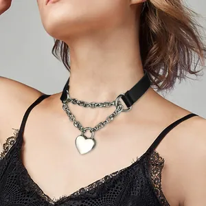 Detail of a heart padlock choker with black leather texture and silver layered chains