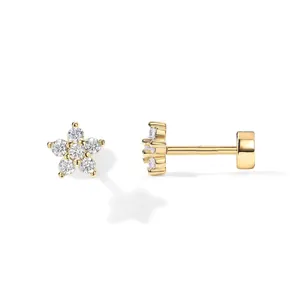 Gold plated brass palm flower earrings with clear zircon stones on a white background