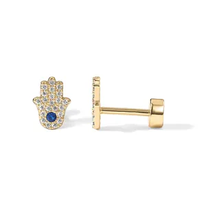 Gold Hamsa Hand earring stud with sparkling zircons and blue center stone on white backdrop