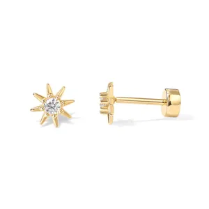 Detail view of 18K gold plated brass star flower stud earrings with zircon center