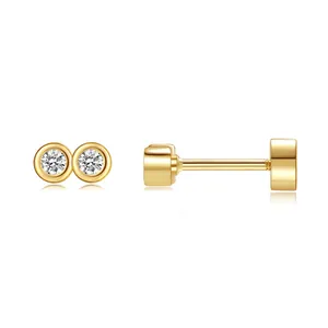 Detail view of round bezel-set zircon earrings in gold finish with flat push-back closure