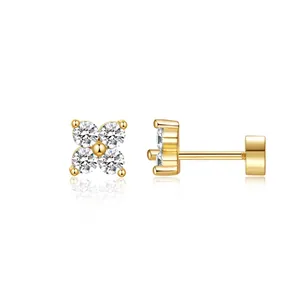 Detail view of gold-plated clover studs with clear zircons, including front and side views