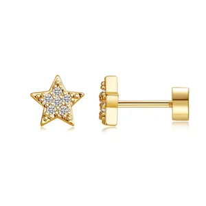 Macro view of gold-plated brass star stud earrings with tiny clear zircon inlay stones