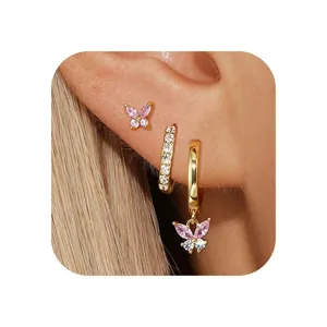 Detail of three-piece gold-plated butterfly earrings set with pink and white zirconia stones