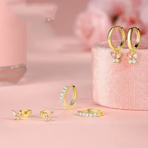 Detailed view of gold butterfly earrings set with pink marquise crystals and sparkling stones
