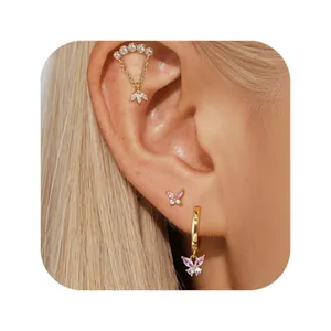 Macro shot of gold brass butterfly earrings set with pink gradient zircon crystals