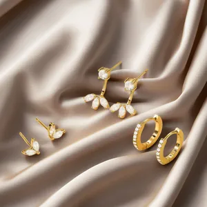 Three-piece set of brass gold plated earrings featuring sparkling marquise and round zircons