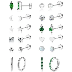 Set of 12 celestial earrings with green zircons, pearls and silver finish on white background