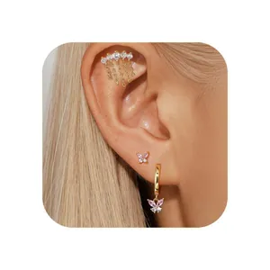 Macro shot of gold-plated butterfly earrings set with sparkling pink zircon crystals