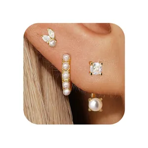 Detail of elegant gold plated butterfly earring set featuring crystals and pearls
