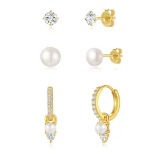 Macro detail of 18K gold plated earring set with zircon, pearls and crystal drops
