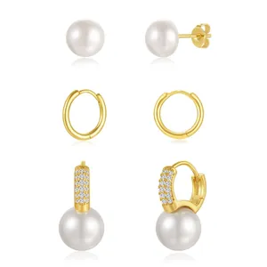Detailed view of three-piece gold brass earring set with pearls and sparkling zircon accents