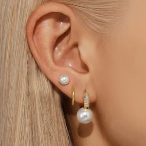 Gold-plated brass earring set with cubic zirconia butterfly and white pearls on model