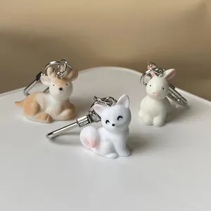 Three cute resin animal keychains featuring a brown deer, white fox, and rabbit with rings