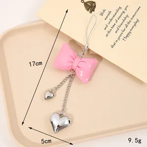 Pink faux leather bow keychain with silver heart pendants for bags and phone decoration