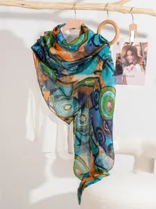 Detailed macro view of colorful abstract printed silk scarf with artistic patterns