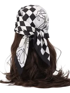 Detail of checkered silk scarf tied on hair showing soft texture and artistic patterns