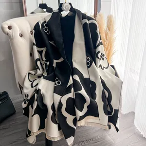Detail of elegant black and white camellia pattern on a thick faux cashmere scarf