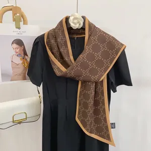 Close-up of elegant silk scarf with leopard border and geometric patterns on a dress