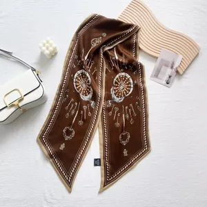 Detail of vintage key print silk scarf with chain pattern on white leather bag