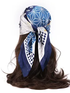 Detail view of navy blue silk-like headscarf with geometric dots on long brown hair