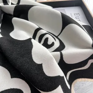 Elegant cashmere-like scarf with black and white camellia pattern and fringe edge