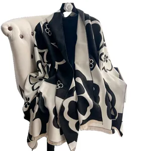 Elegant black and white camellia pattern cashmere-feel scarf with long fringe details
