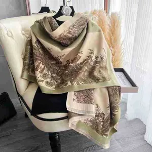 Detail of vintage floral cashmere-like scarf with soft fringe on a stylish chair