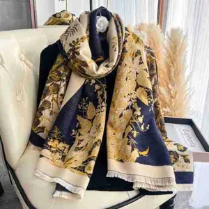 Detailed close-up of retro floral pattern and fringe edges on a warm cashmere shawl