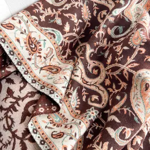 Close-up of cashmere-like paisley jacquard fabric showing intricate woven details and soft texture