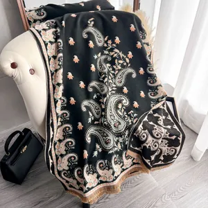 Close-up of black paisley pashmina shawl featuring soft fringes and intricate patterns