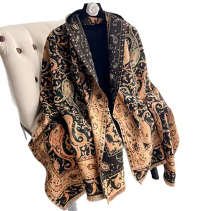 Classic paisley pattern cashmere shawl with short tassels on a white leather chair