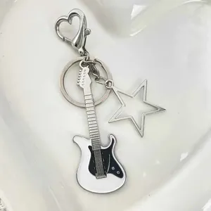 Y2K electric guitar keychain with a hollow star charm and a heart-shaped carabiner
