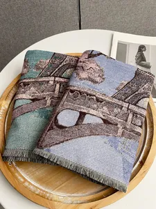 Detailed view of woven vintage floral scarves with fringe edges in a wooden tray