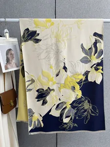 Dettaglio di sciarpa invernale in cashmere con grandi motivi di fiori di magnolia