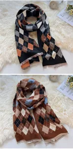 Close-up of classic argyle pattern long scarf with delicate fringes in warm winter tones
