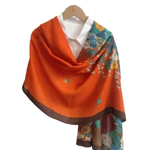 Orange floral cotton linen scarf shawl with brown border on a white shirt