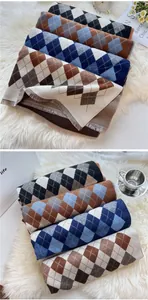 Detail of soft argyle knit scarves with short fringe edges in four classic color combinations