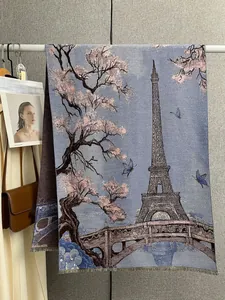 Detailed close-up of a floral scarf with Eiffel Tower pattern and delicate tassels