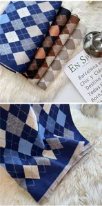 Macro view of argyle knit scarf texture and fringe detail for winter accessories