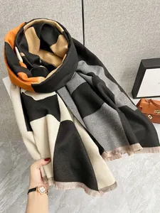 Dettaglio di sciarpa scozzese multicolore con frange e morbida consistenza effetto cashmere