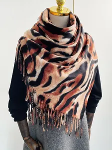 Dettaglio dello scialle effetto cashmere con stampa tigre, frange fitte e tessuto caldo