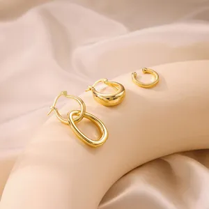 Detailed view of 18K gold plated brass earrings and ear cuff with zircon inlay