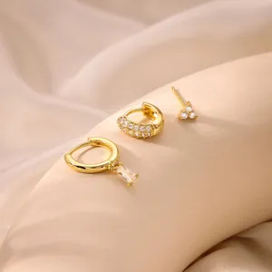 Detailed set of gold plated brass hoop earrings with cubic zirconia and baguette drop