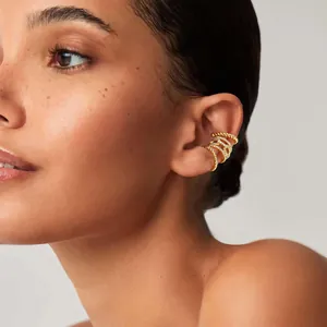 Gold-plated twist cuff earrings set with shimmering pave-set white cubic zirconia stones