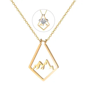 Gold mountain peak hollow pendant necklace holding a heart ring on white background