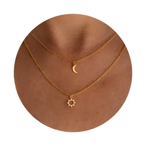 Double-layer gold plated brass necklace with sun and crescent moon pendants on model