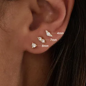 Detail showing 4mm 7mm and 8mm gold starfish and butterfly stud earrings on ear